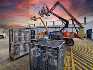 A dusk scene of a Korean urban infrastructure construction site with safety fences and signage in blue and yellow tones.
