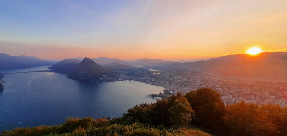 a body of water surrounded by trees and hills