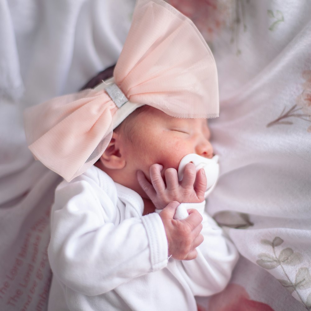 a baby in a white outfit