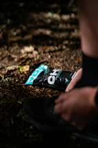 Bright and energizing image of a runner tying shoes on a colorful trail.