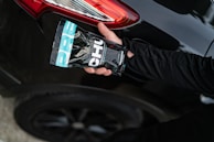 Customer receiving high-quality auto parts package with a satisfied smile.