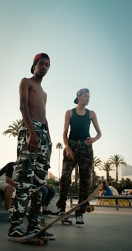 Group of diverse young men showcasing coordinated streetwear outfits in a skate park.