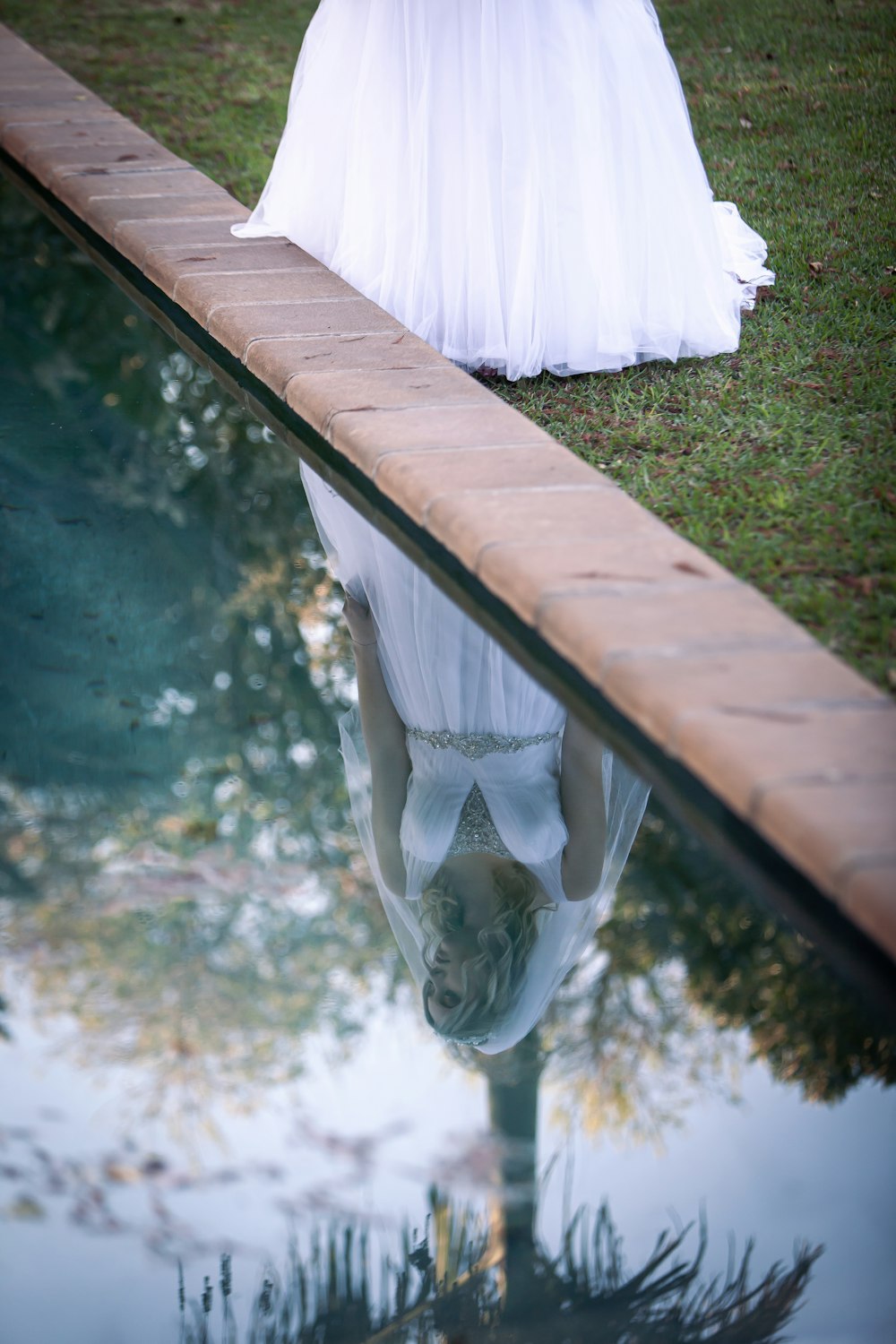 a white umbrella over a wooden bench