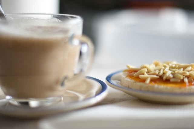 a plate of food next to a mug of coffee