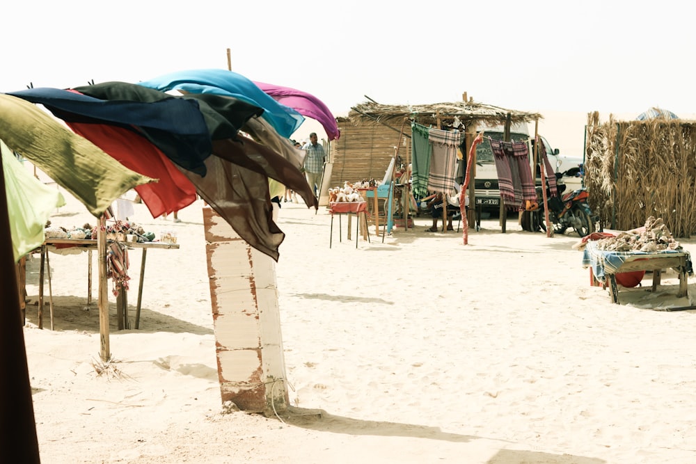 a beach with a hut and chairs