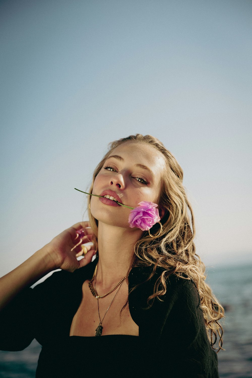 a woman with a flower in her mouth