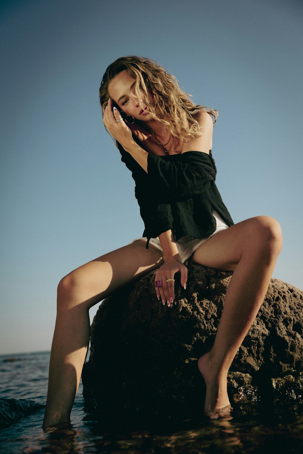 a woman sitting on a rock