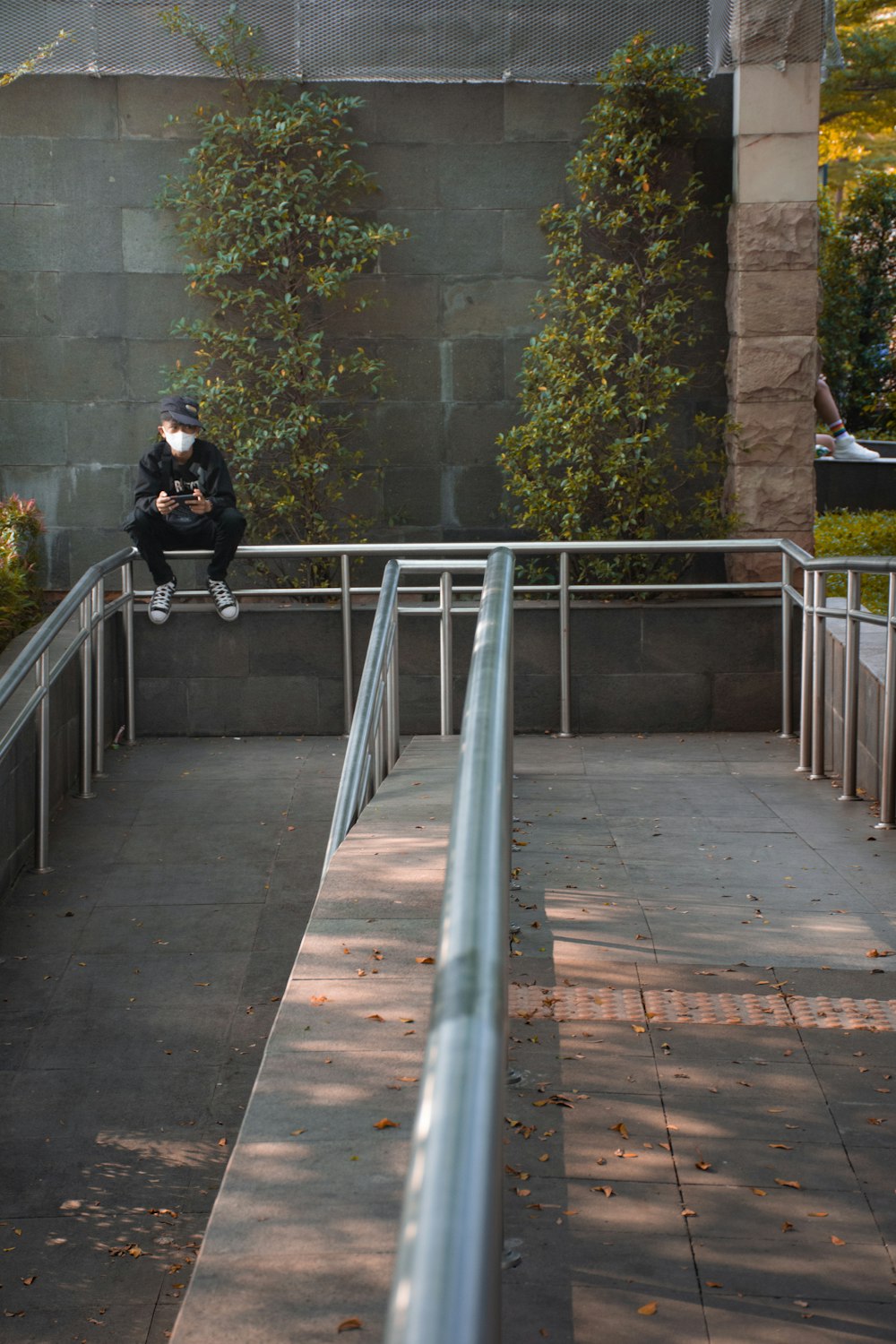 a person sitting on a metal railing
