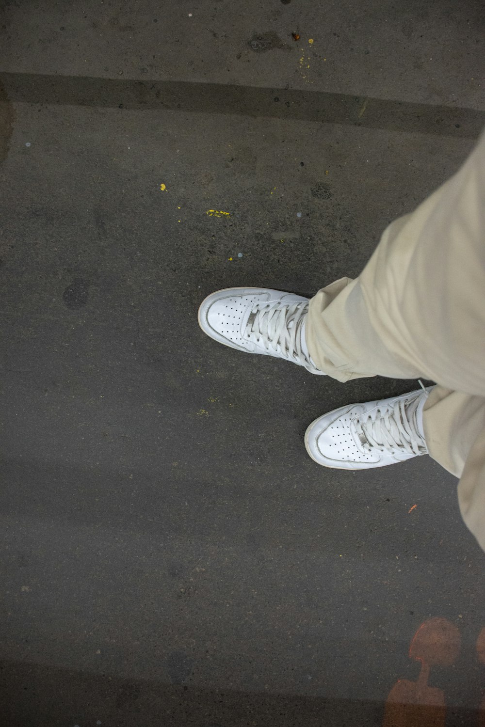 a person's feet on a concrete surface