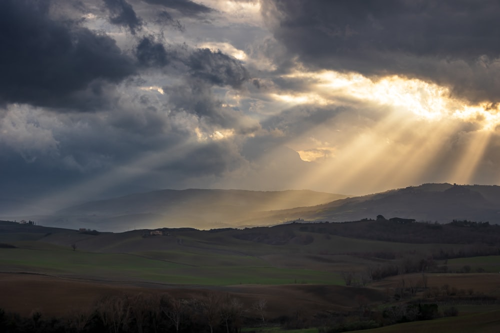 a landscape with hills and clouds