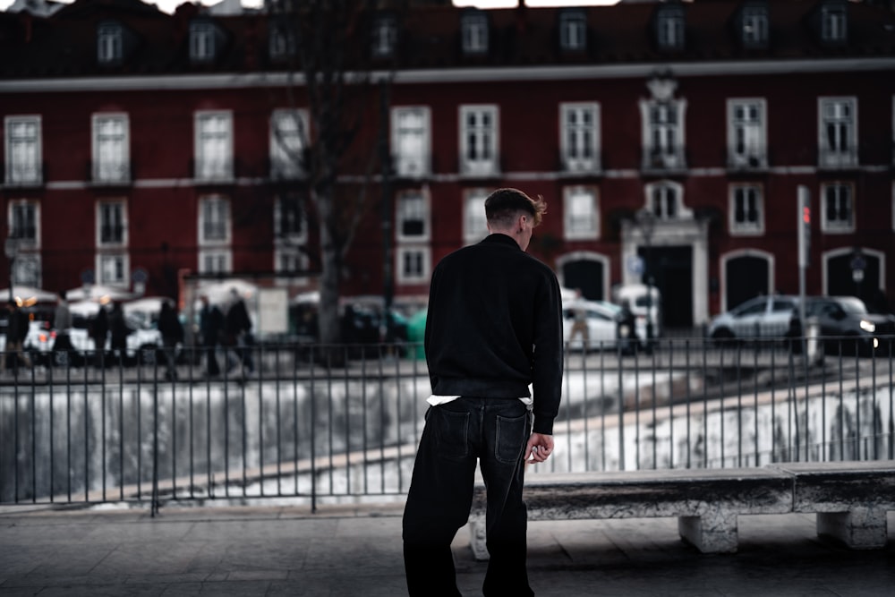 a man walking on a sidewalk