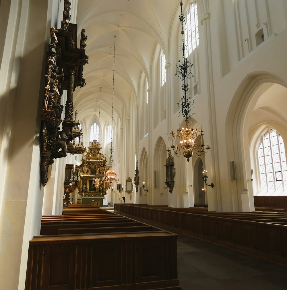 a large church with a large chandelier and pews