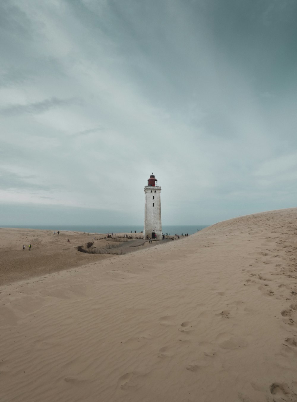 a lighthouse on a sandy beach