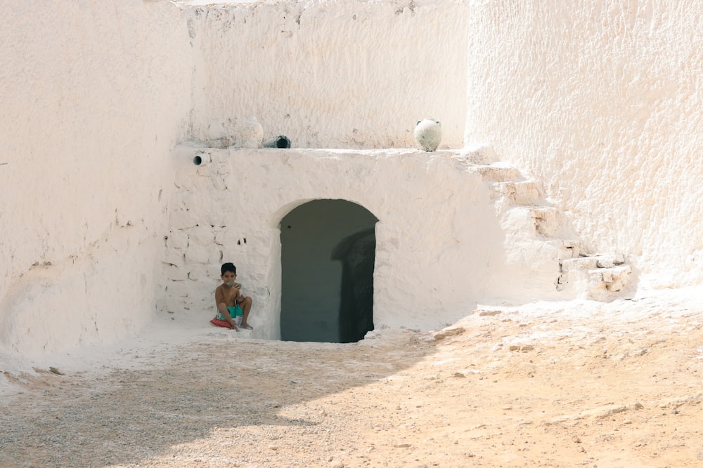 a child sitting in a doorway