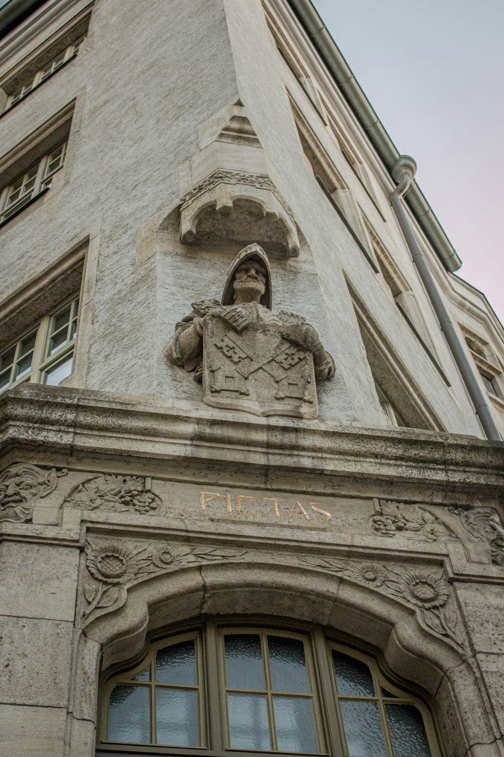 a stone building with a statue on the front