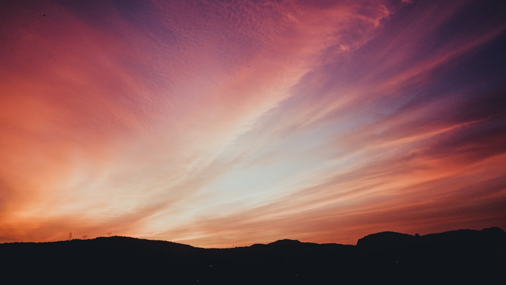 a sunset over a mountain range