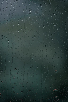 Close-up of droplets sliding off spotless glass windows after osmo clean.