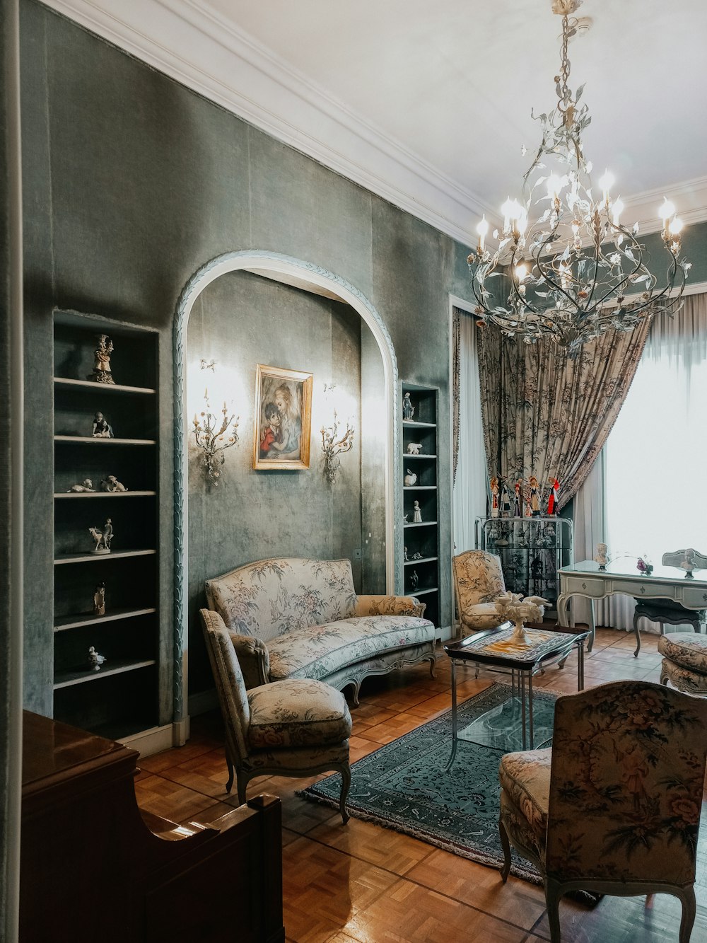 a living room with a chandelier and a couch