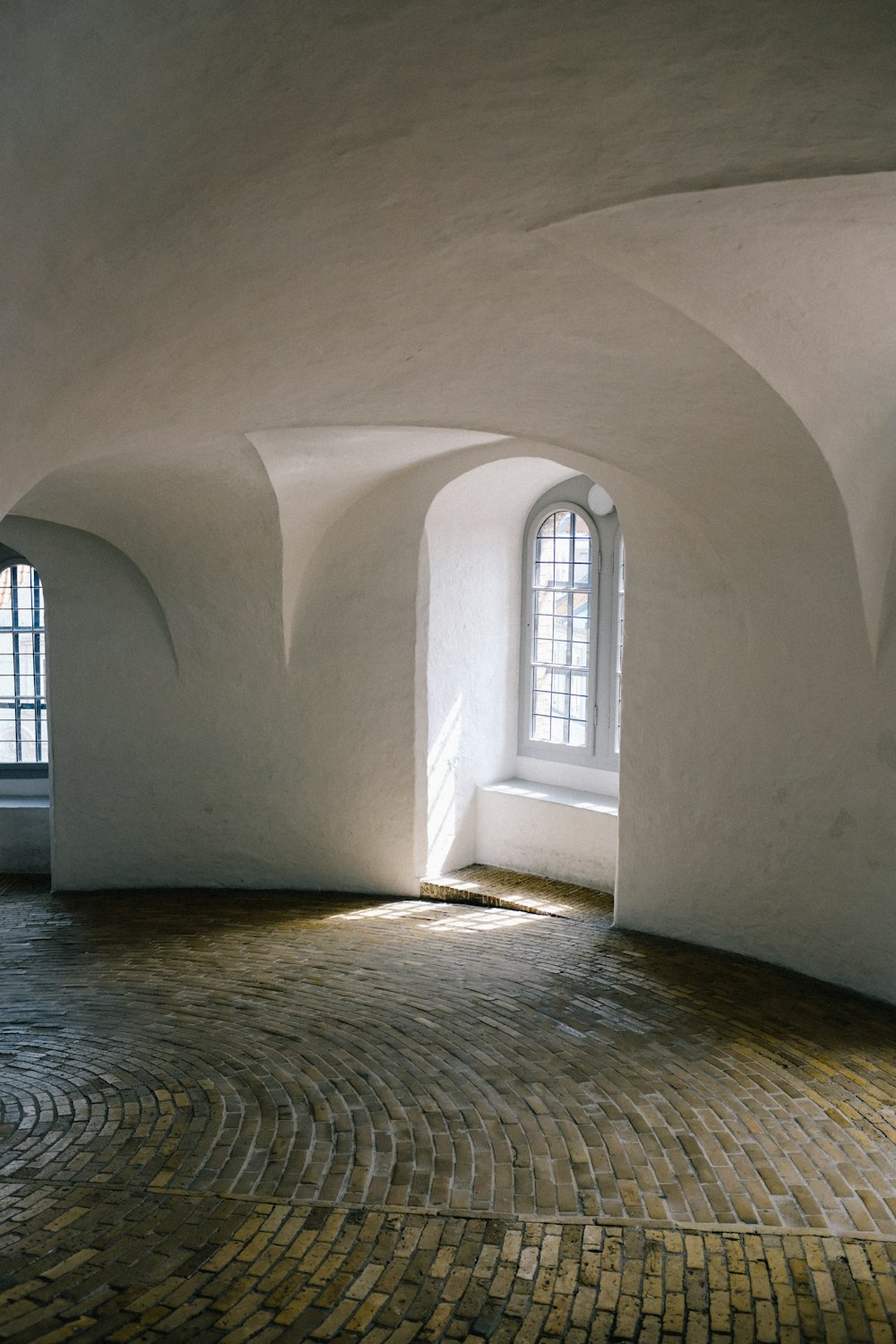 a stone hallway with windows