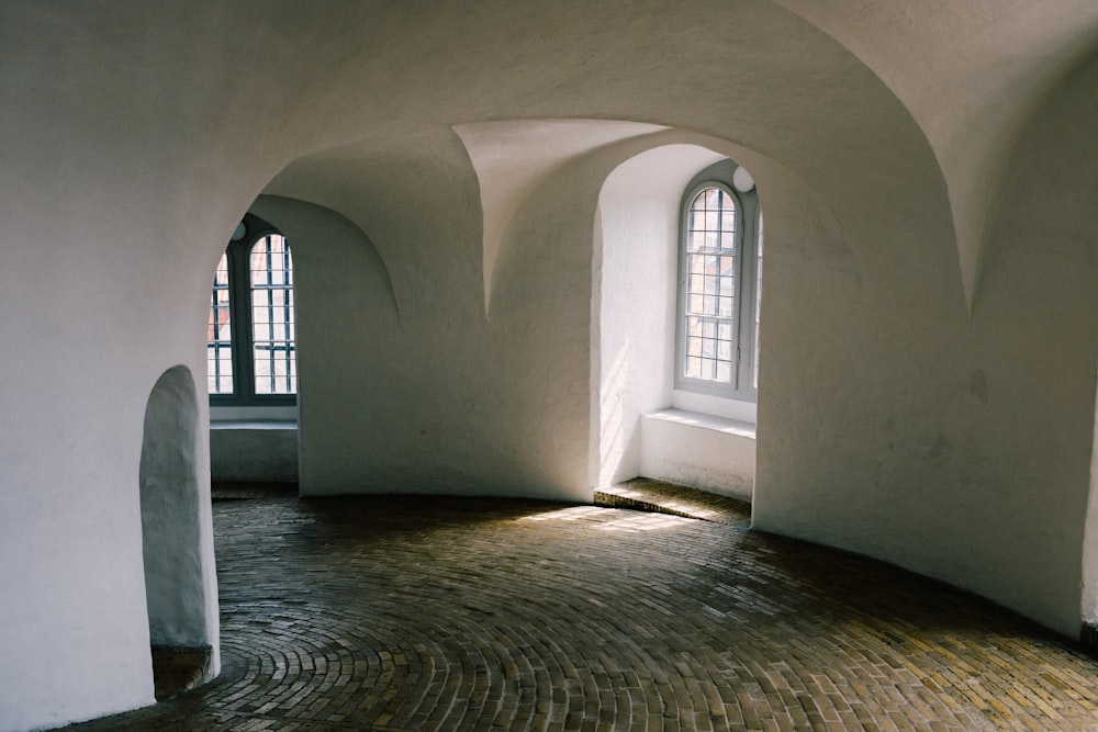 a room with windows and a rug