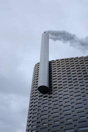 a tall building with smoke coming out of it
