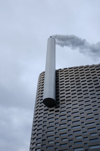 a tall building with smoke coming out of it