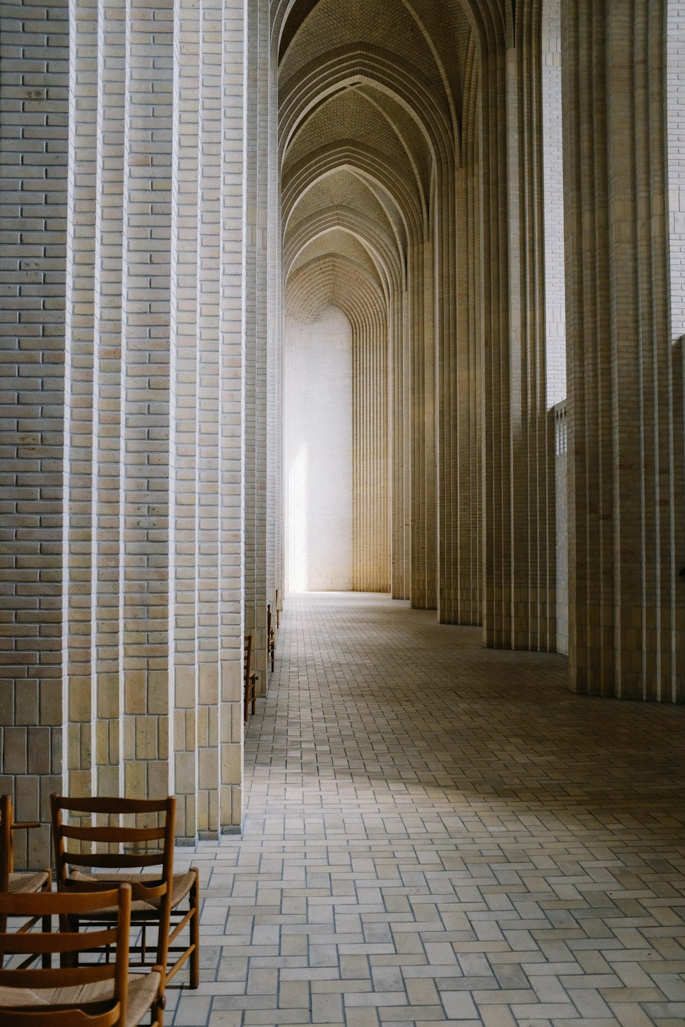 a brick hallway with a chair