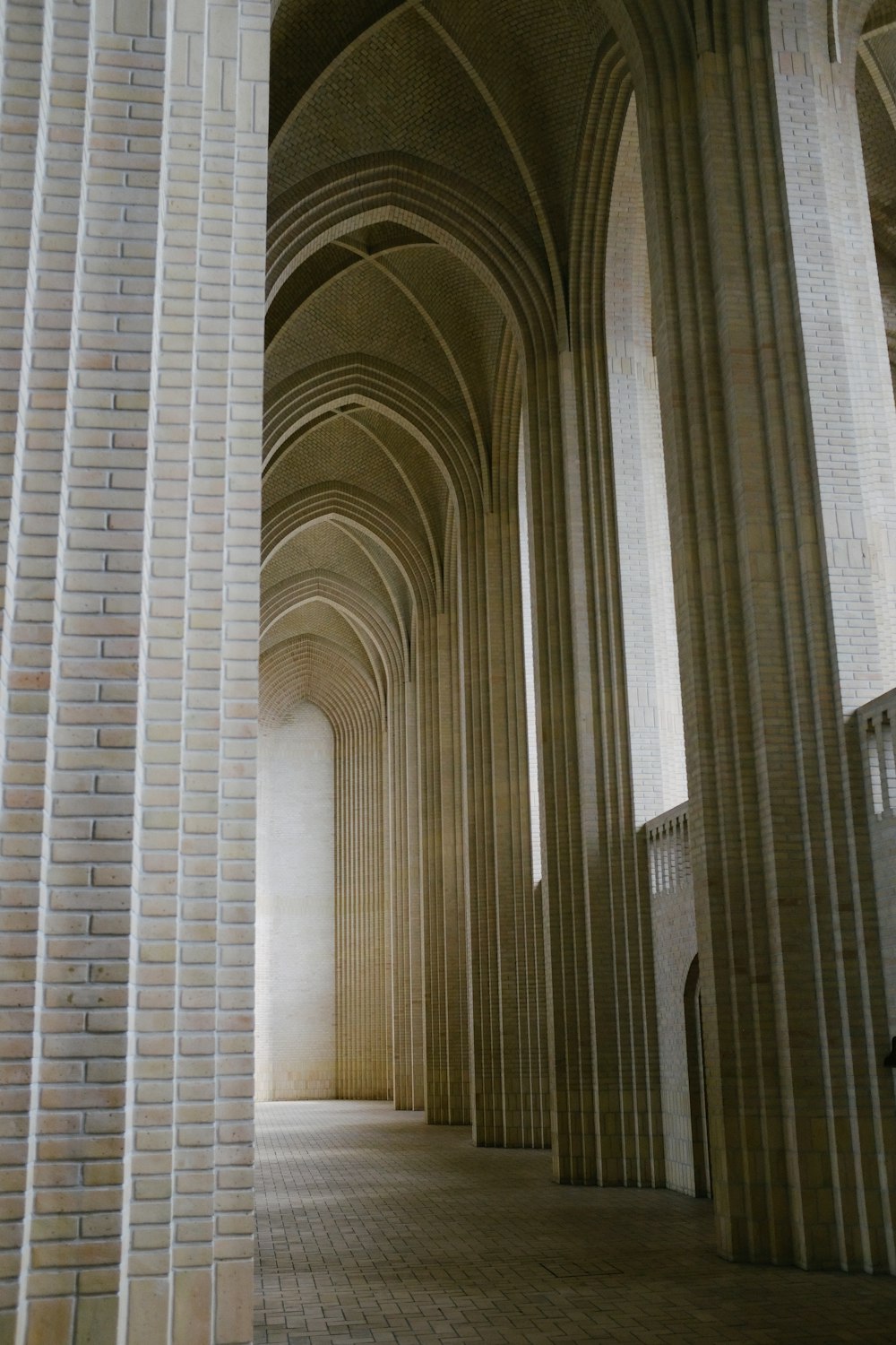 a hallway with white pillars