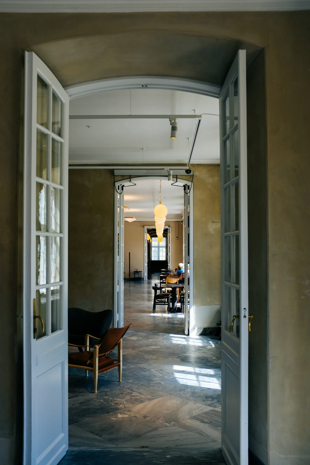 a hallway with a table and chairs