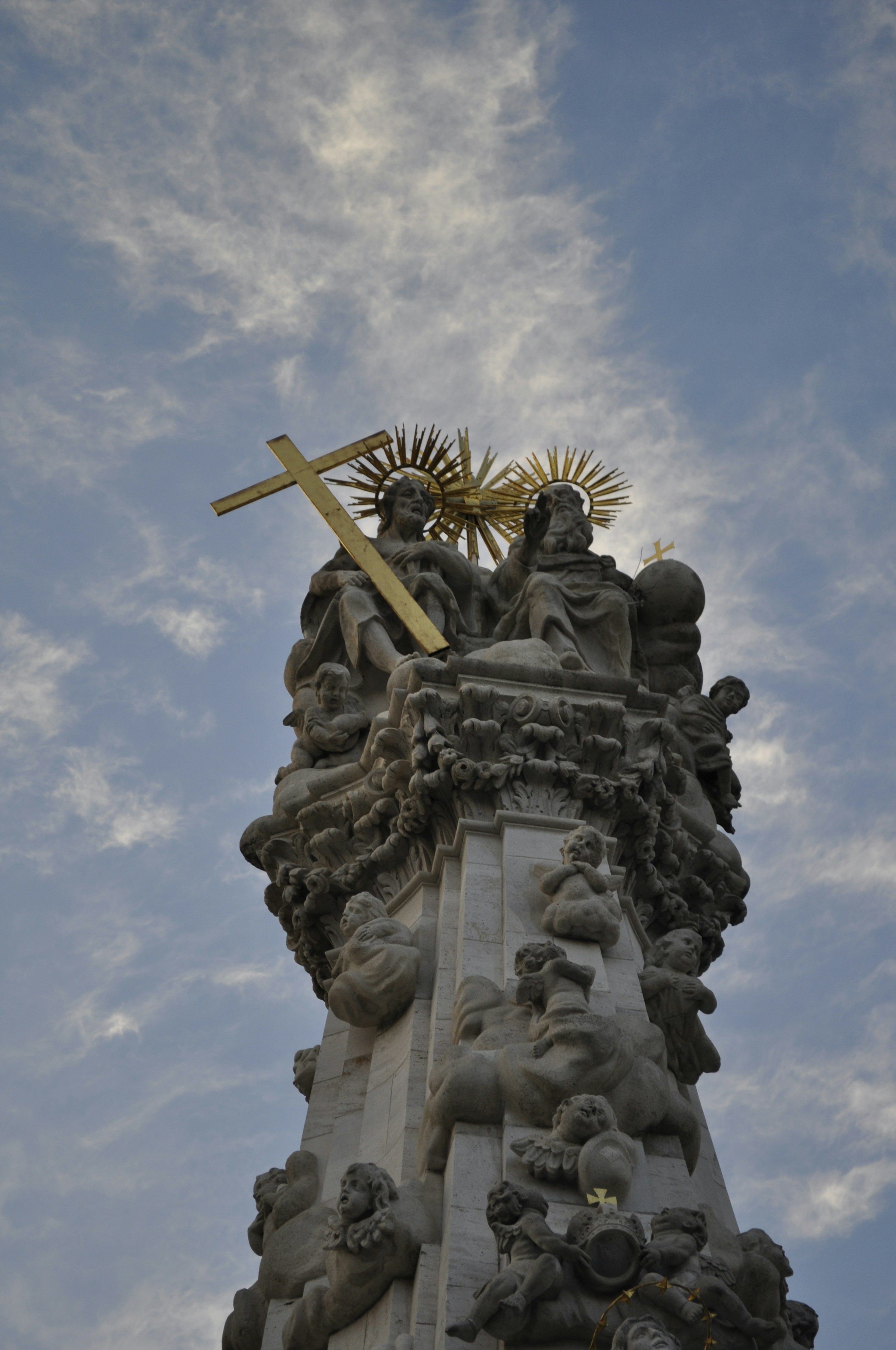 a statue of a person holding a cross