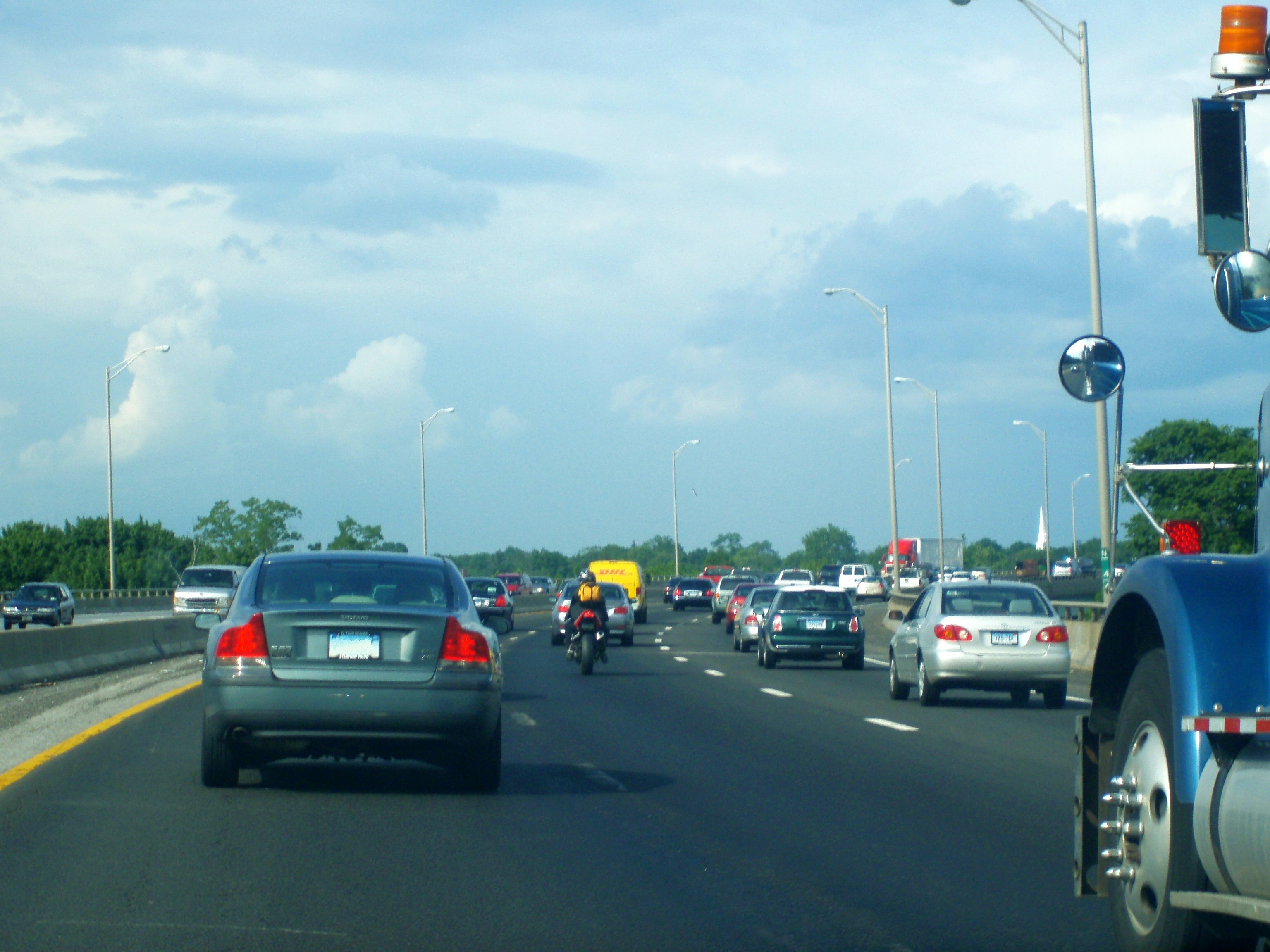 a motorcycle and cars driving down the road