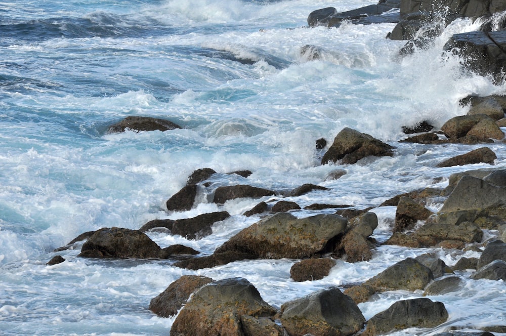 a rocky beach with waves crashing