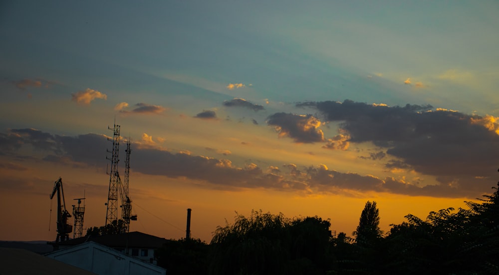 a sunset over trees and power lines