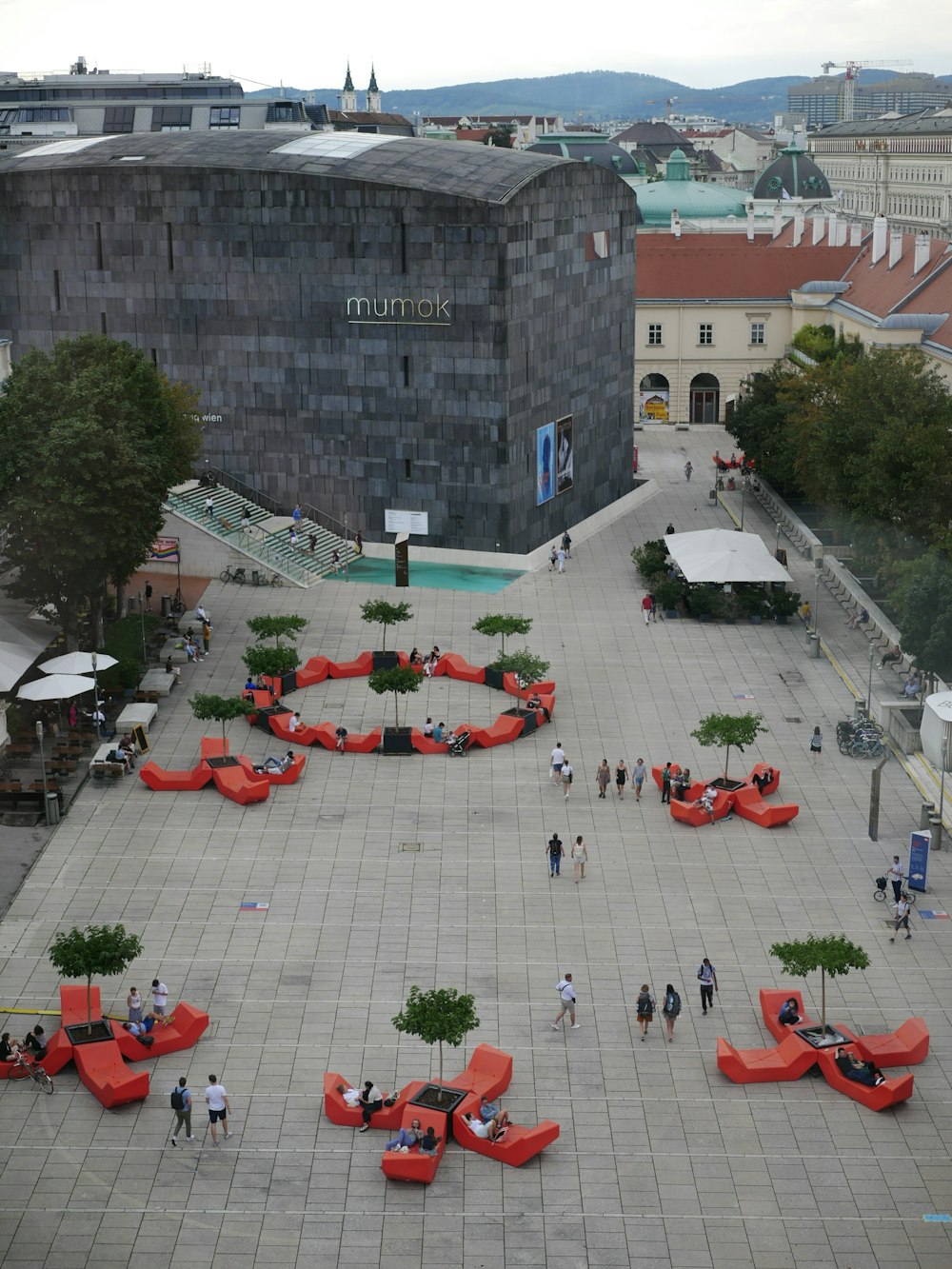 a courtyard with a building and people