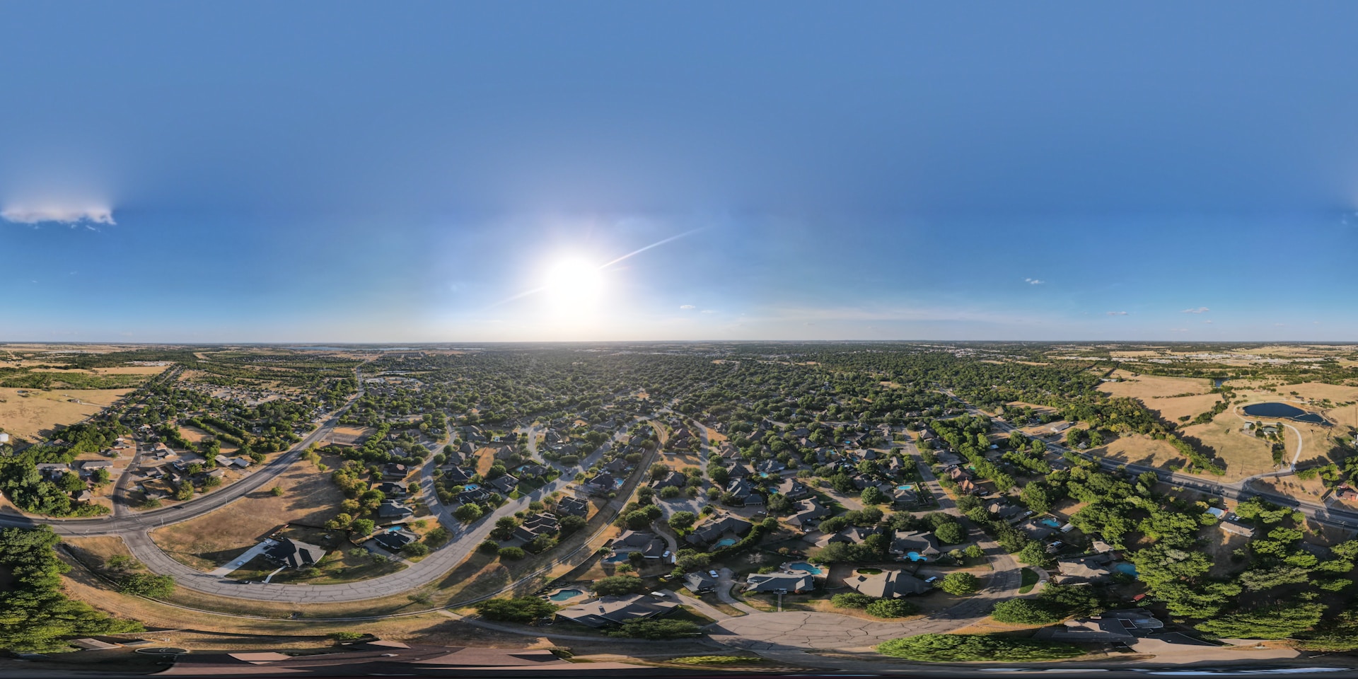 a landscape with a road and buildings