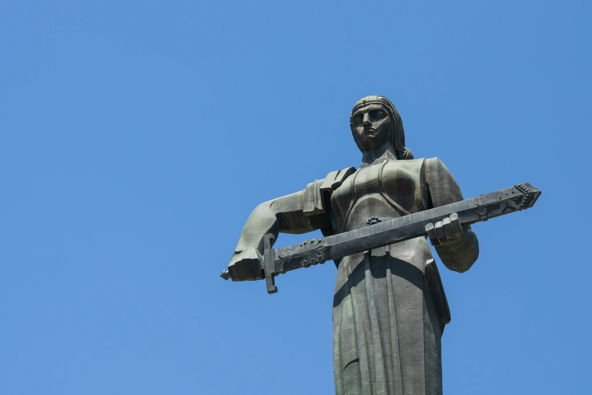 a statue of a person holding a cross