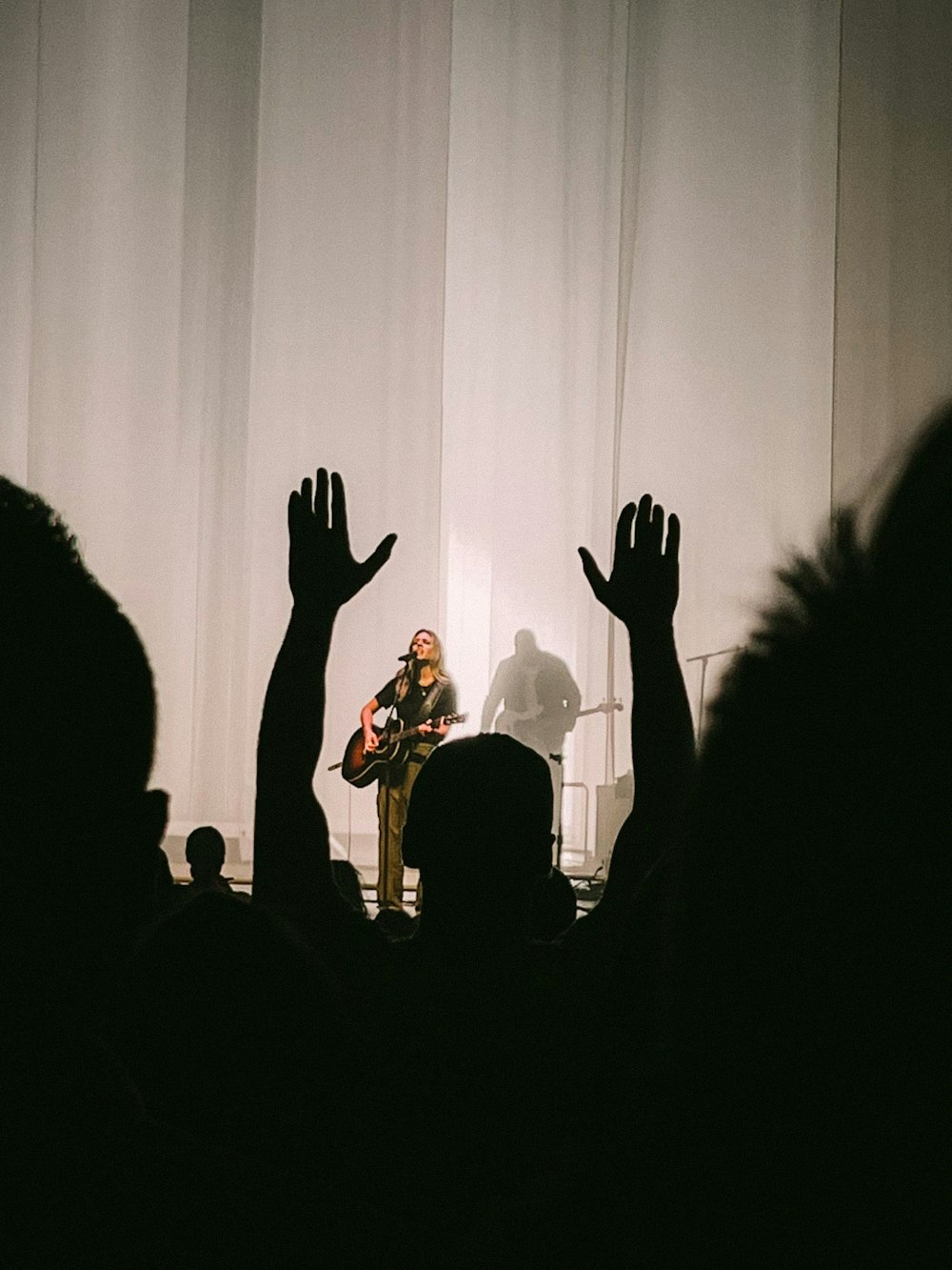 a group of people on a stage with a band playing