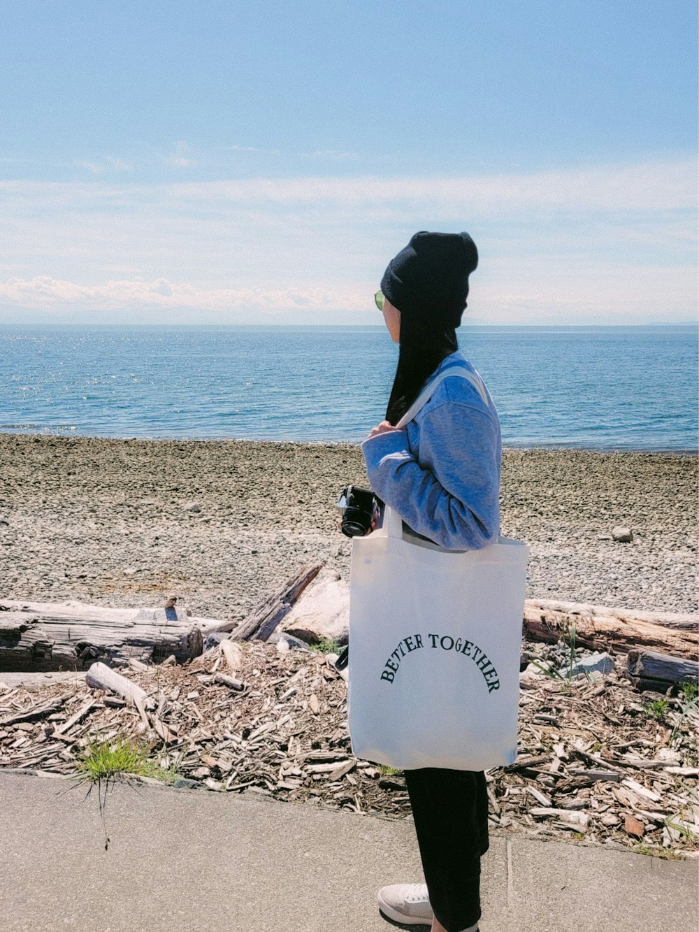 a person carrying a large white container on a beach