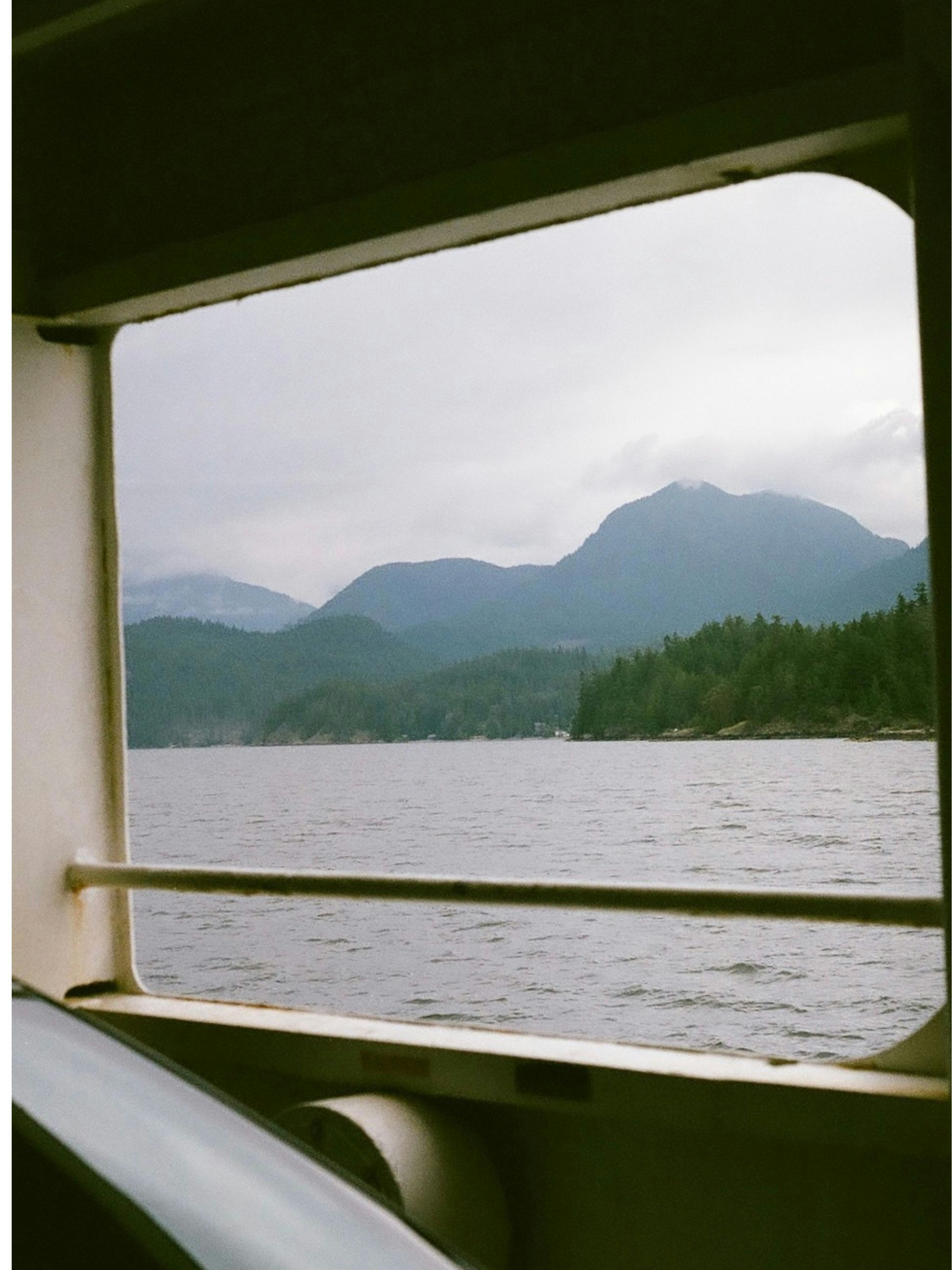 a view of a lake and mountains from a window