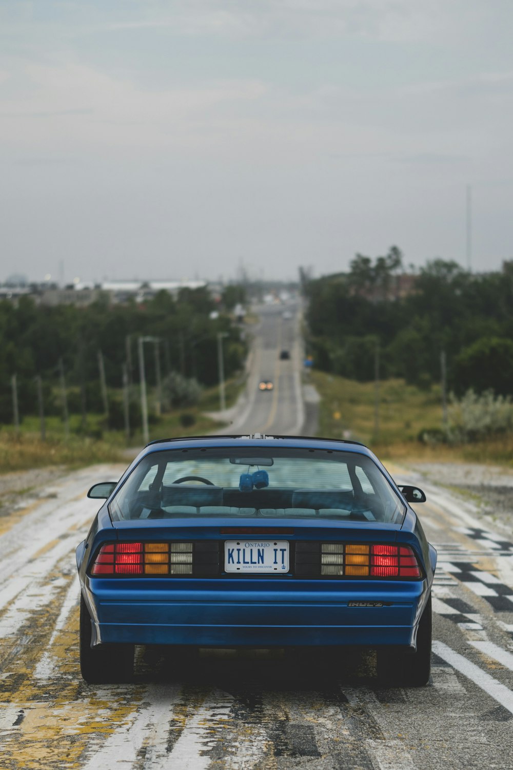 a blue car on a road