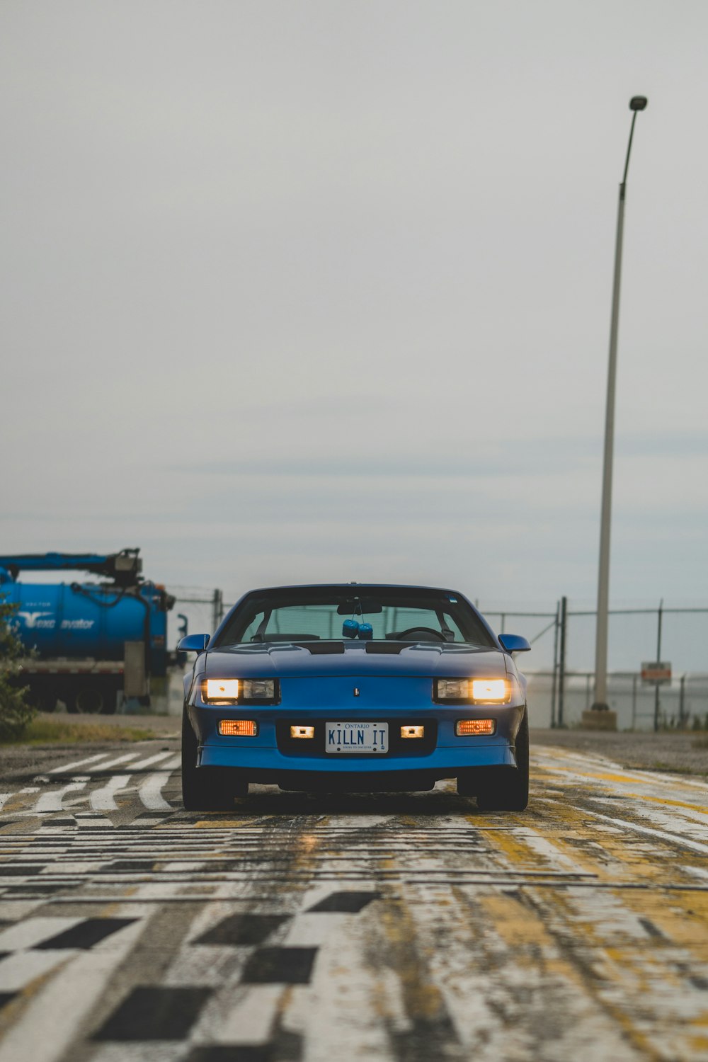 a blue car on a road