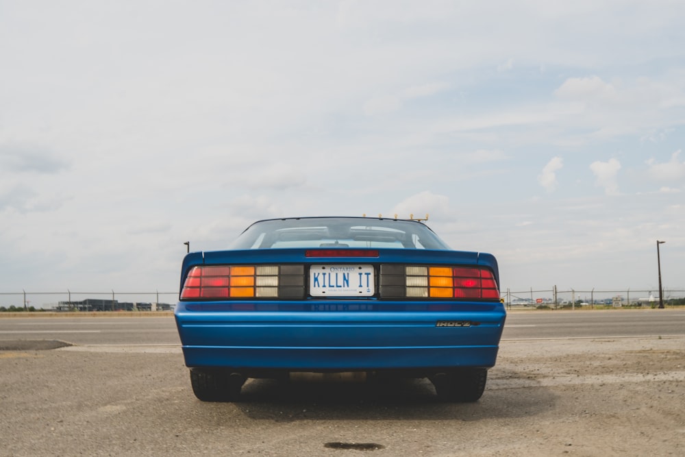 a blue car on a road