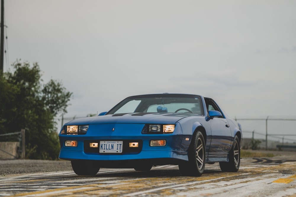 a blue car on a road