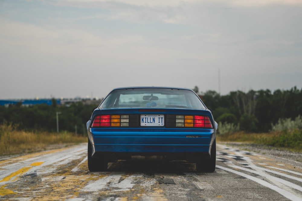 a blue car on a road