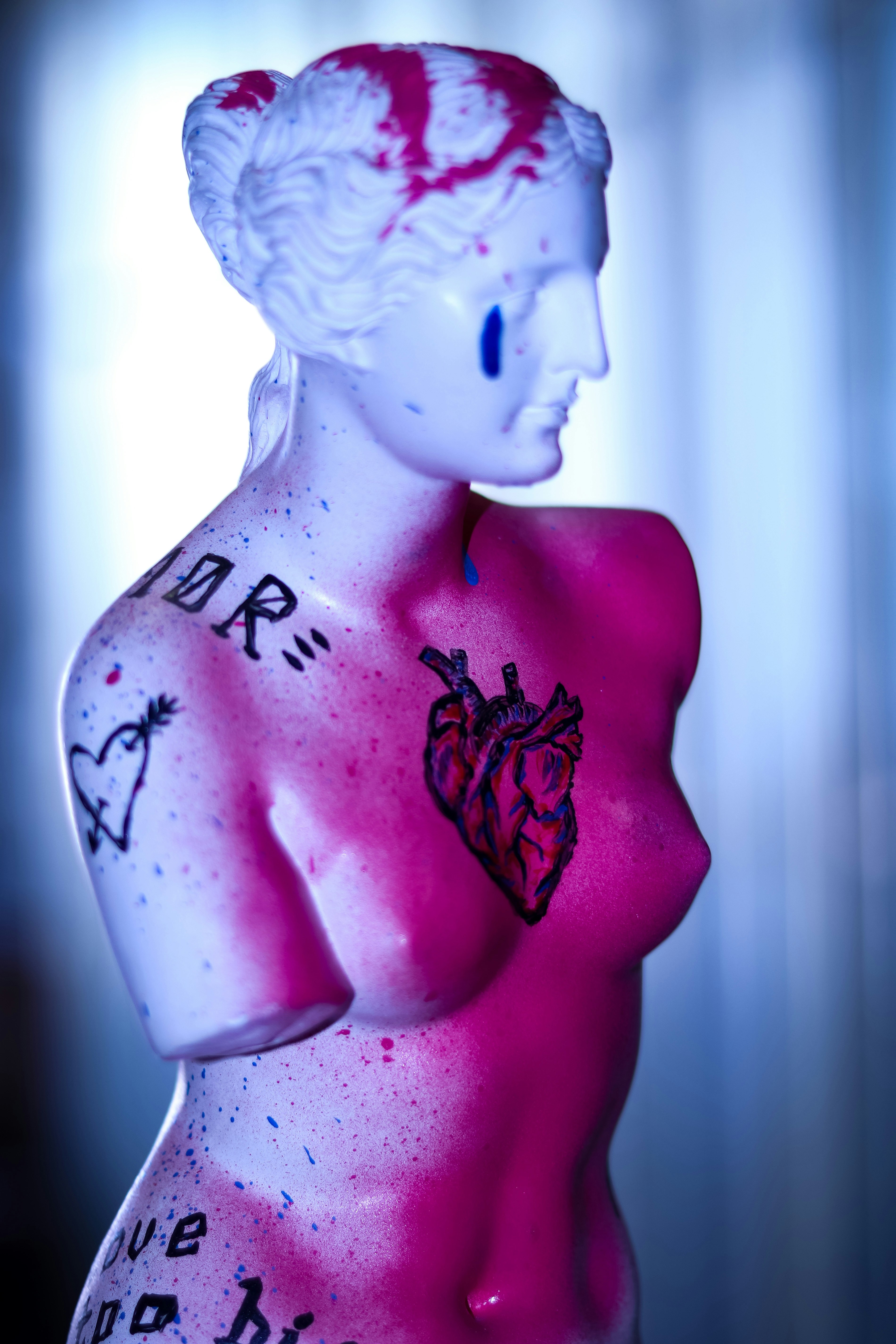 a mannequin wearing a pink dress with a flower on it