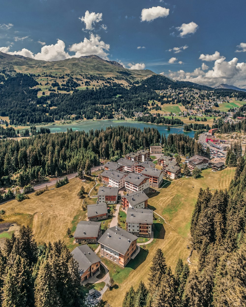 a large building surrounded by trees and a body of water