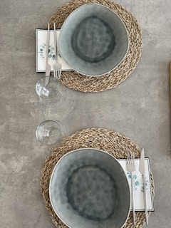 Woven placemats in earthy tones arranged neatly under ceramic plates, creating a warm and inviting table setting.