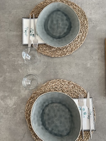 Woven placemats in earthy tones arranged neatly under ceramic plates, creating a warm and inviting table setting.