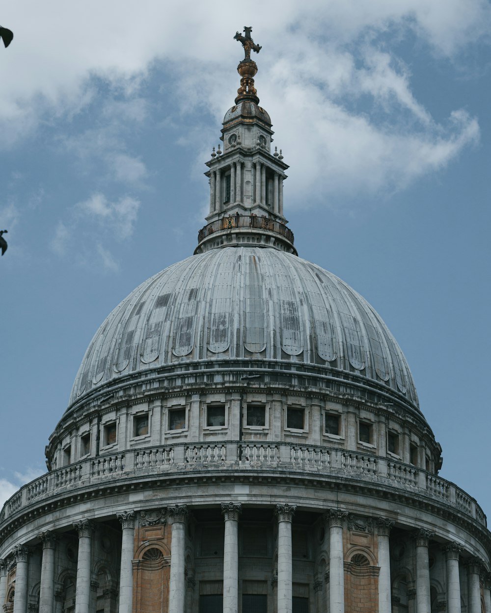 a domed building with columns and a cross on top