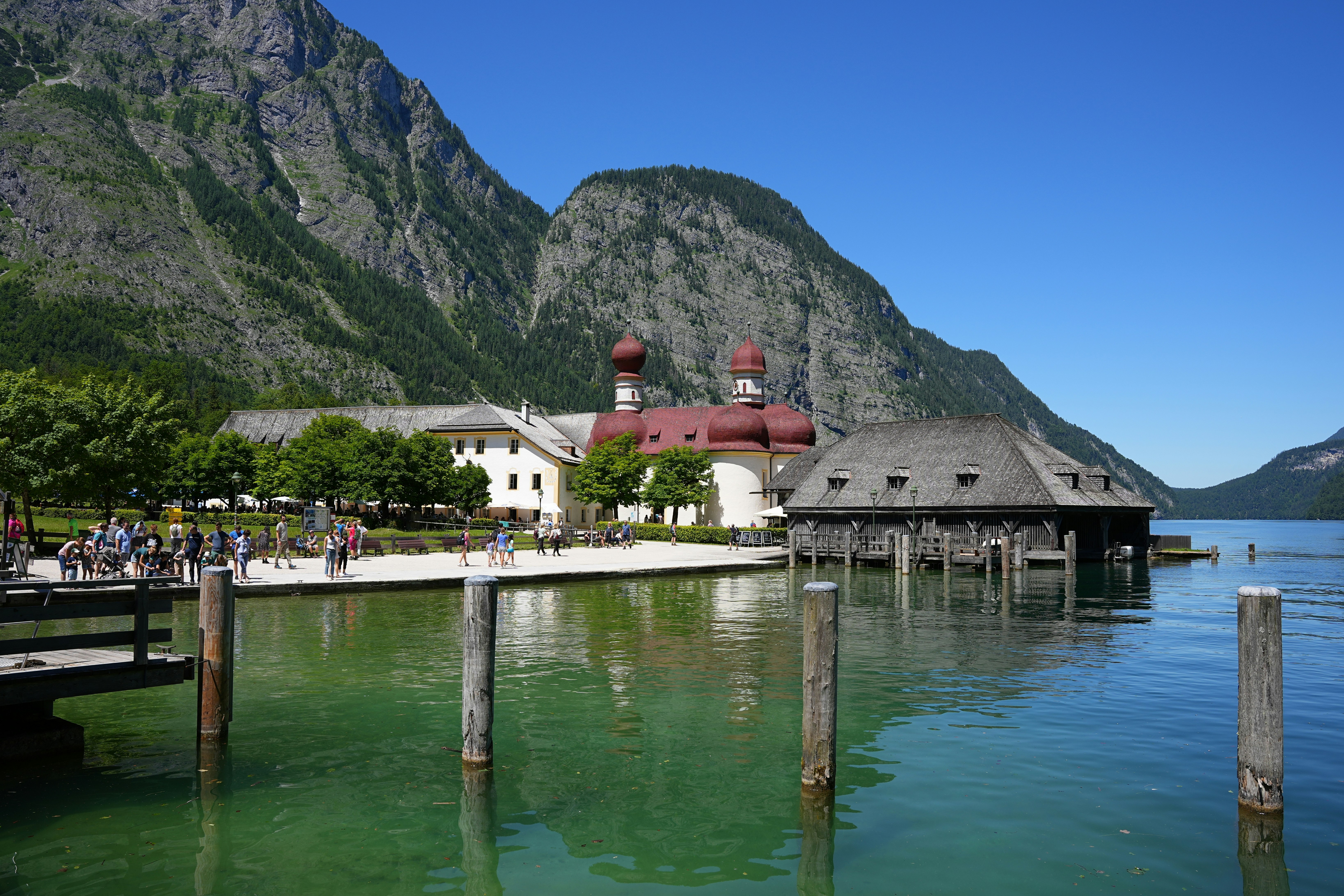 a group of people on a dock by a body of water